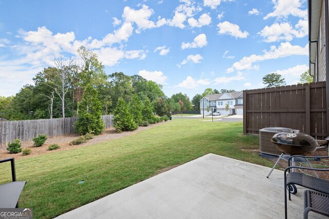 view of yard featuring cooling unit, a patio area, and fence