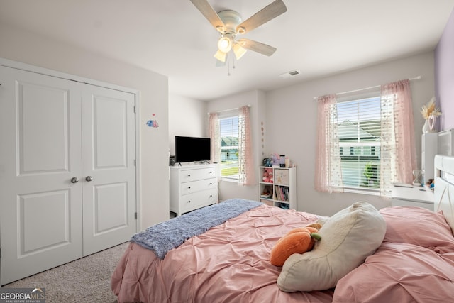 bedroom featuring carpet flooring, visible vents, a closet, and ceiling fan