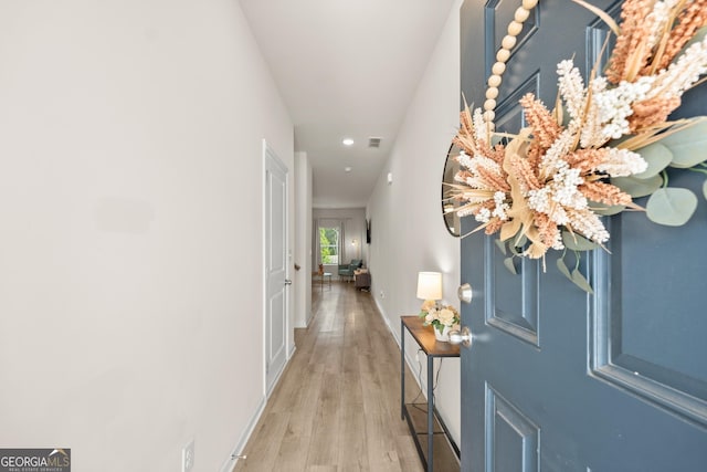 interior space with visible vents, baseboards, and wood finished floors