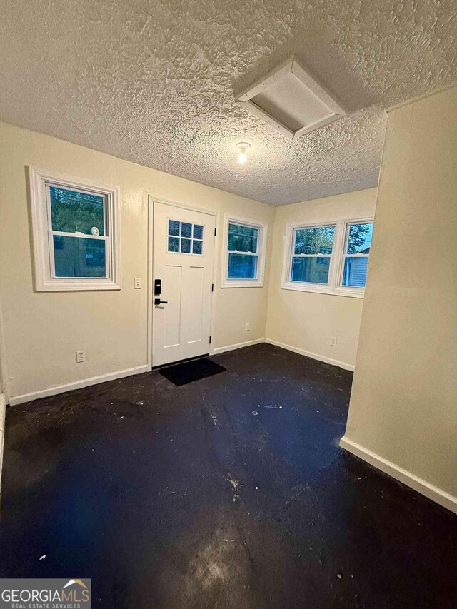 entryway featuring concrete flooring and a textured ceiling