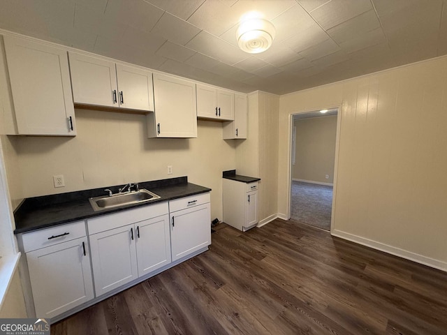 kitchen featuring dark hardwood / wood-style floors, sink, and white cabinets