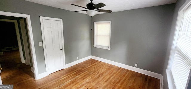 unfurnished bedroom with ceiling fan and light hardwood / wood-style flooring