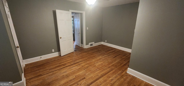 unfurnished bedroom with wood-type flooring