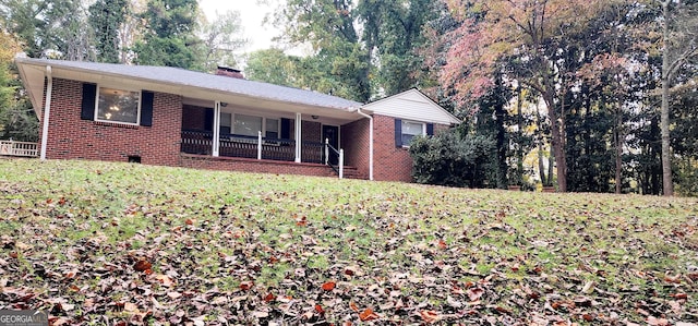 ranch-style home with a porch and a front lawn