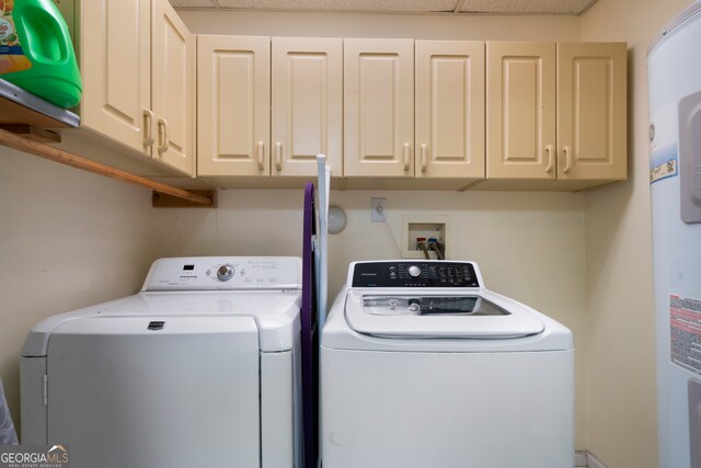 clothes washing area with cabinets and independent washer and dryer