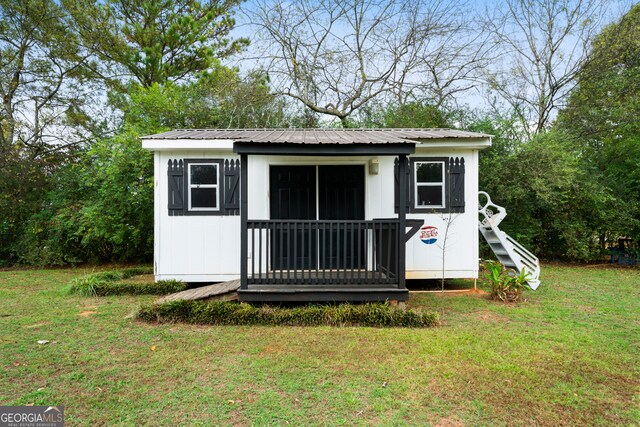 view of outbuilding featuring a yard