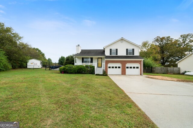 tri-level home with a garage and a front yard