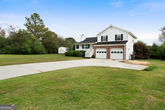 view of front of property with a garage and a front yard