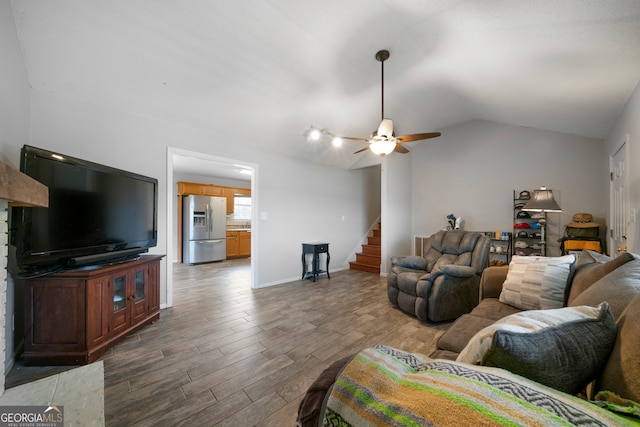 living room featuring ceiling fan, dark hardwood / wood-style floors, and vaulted ceiling