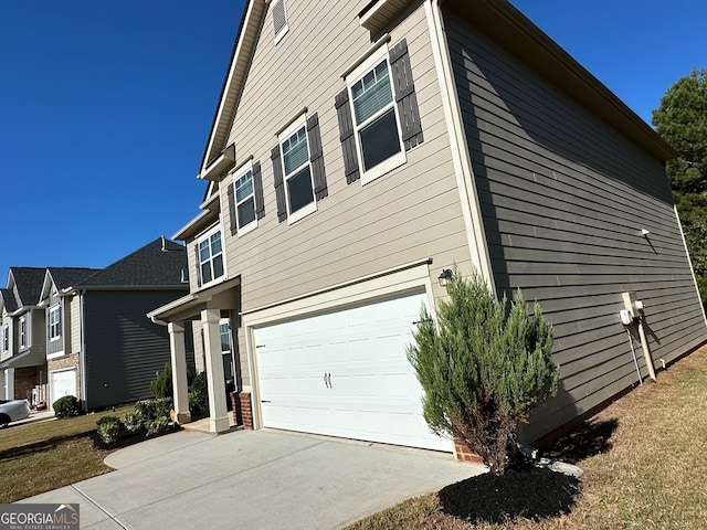 view of side of home featuring a garage