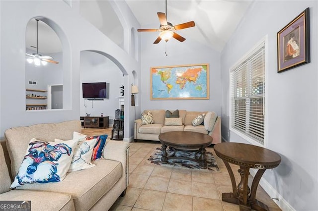 living room with high vaulted ceiling, light tile patterned flooring, and ceiling fan