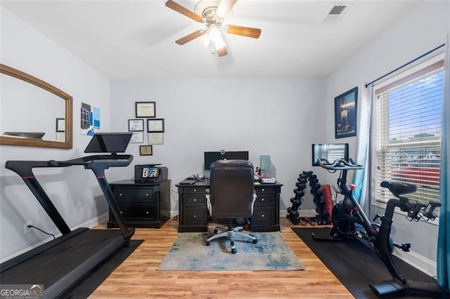 home office featuring light hardwood / wood-style flooring and ceiling fan