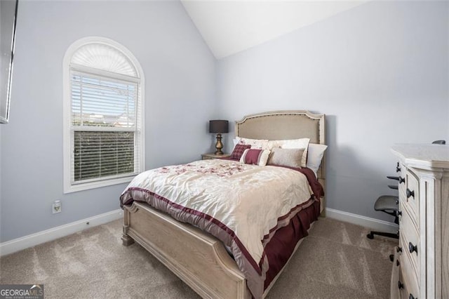 bedroom featuring light colored carpet and vaulted ceiling