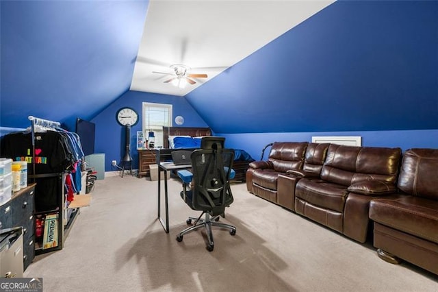 carpeted home office with lofted ceiling and ceiling fan