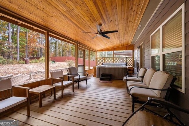 sunroom featuring lofted ceiling, wood ceiling, and ceiling fan