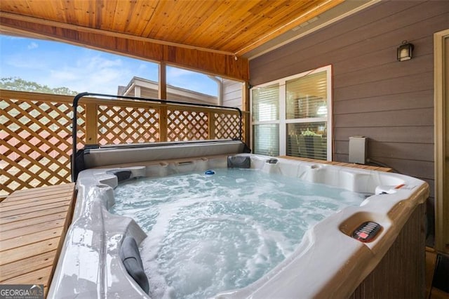 wooden terrace with a hot tub