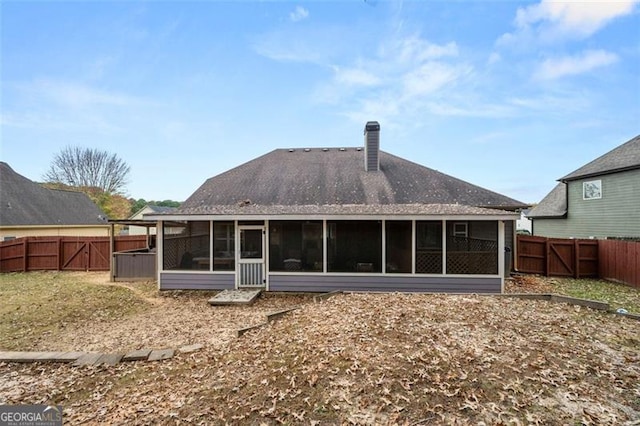 rear view of property with a sunroom