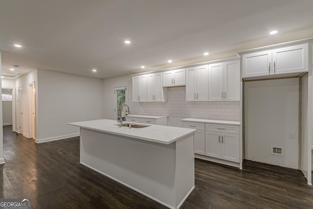 kitchen featuring a center island with sink, dark hardwood / wood-style floors, white cabinetry, and sink