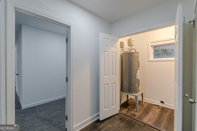 hall with water heater and dark hardwood / wood-style flooring