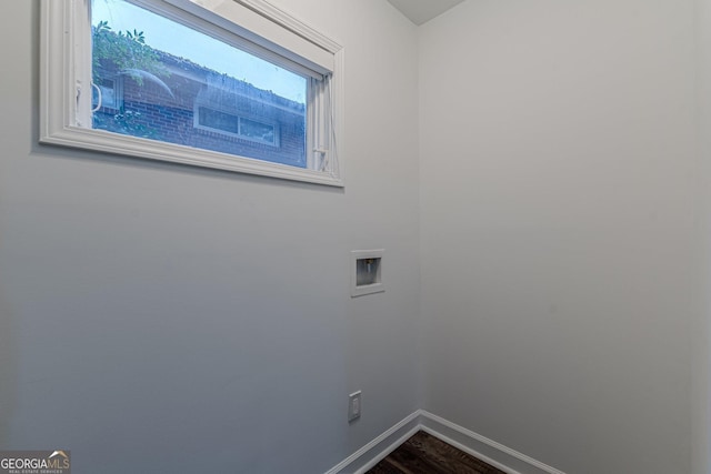 washroom with hardwood / wood-style floors and hookup for a washing machine