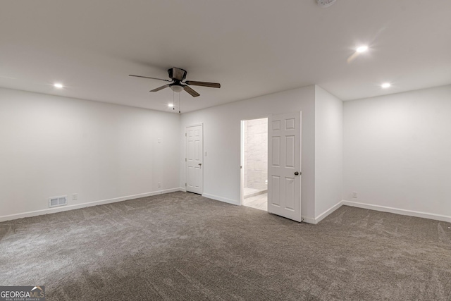 empty room featuring ceiling fan and carpet