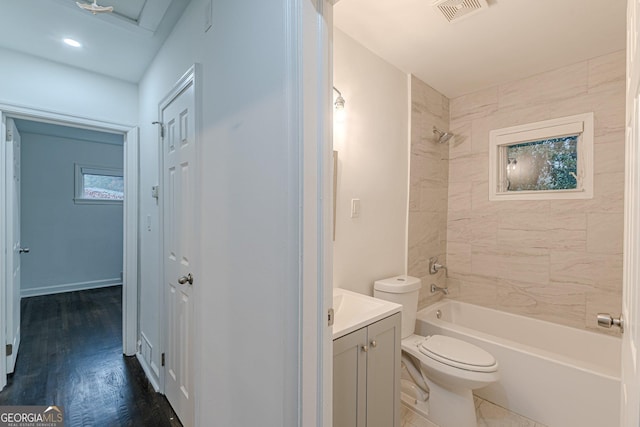 full bathroom with toilet, vanity, tiled shower / bath combo, and hardwood / wood-style flooring