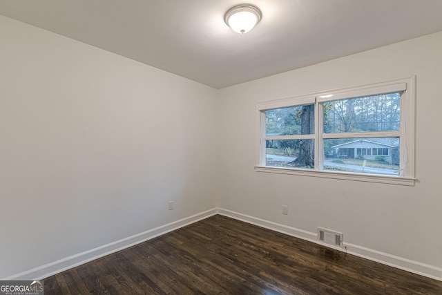 unfurnished room featuring dark hardwood / wood-style floors