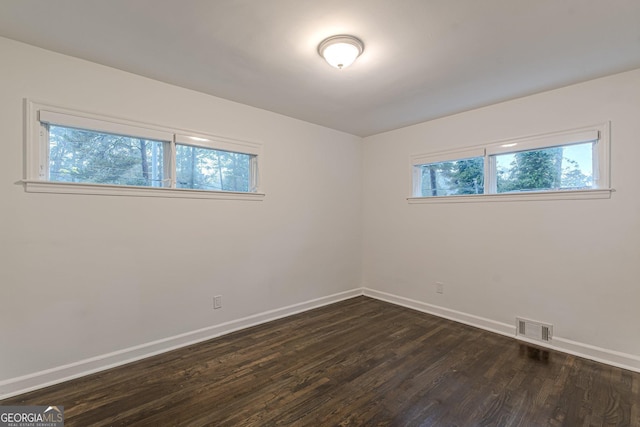 spare room featuring dark hardwood / wood-style floors