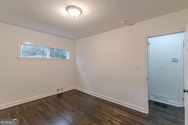 unfurnished room featuring dark hardwood / wood-style flooring