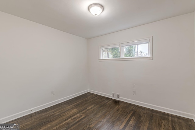 unfurnished room with dark hardwood / wood-style floors