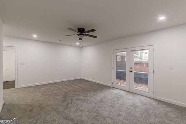 carpeted empty room with ceiling fan and french doors