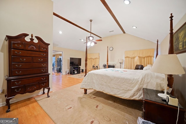 bedroom with ceiling fan, light hardwood / wood-style floors, and vaulted ceiling