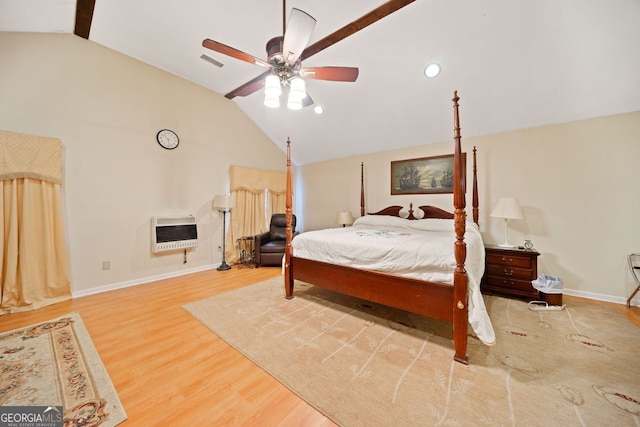 bedroom with lofted ceiling with beams, ceiling fan, wood-type flooring, and heating unit