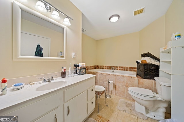 bathroom featuring tile patterned flooring, a relaxing tiled tub, toilet, and vanity