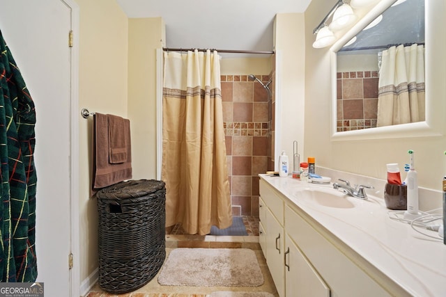 bathroom with a shower with shower curtain, vanity, and tile patterned flooring