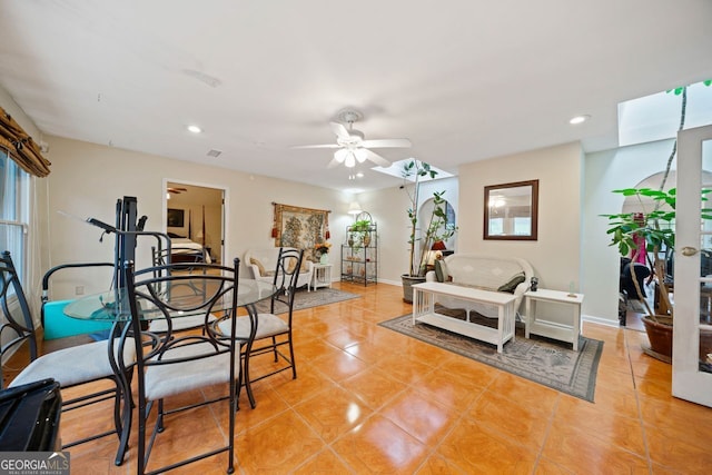 tiled living room with ceiling fan