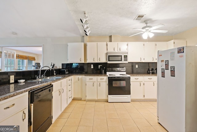 kitchen with tasteful backsplash, white appliances, sink, white cabinets, and light tile patterned flooring