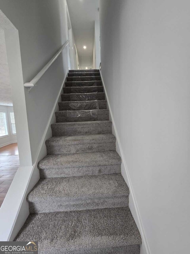 staircase featuring hardwood / wood-style flooring