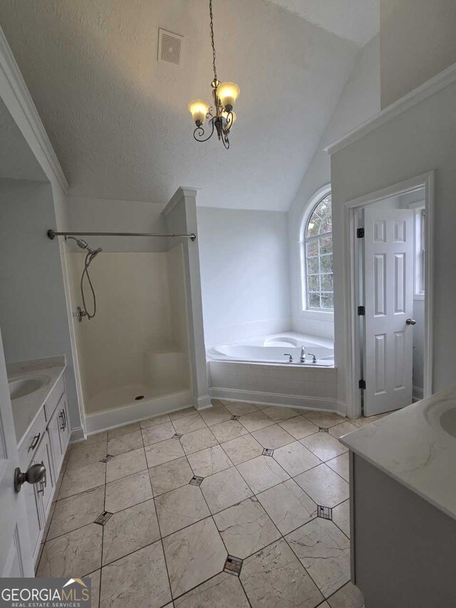 bathroom featuring separate shower and tub, vaulted ceiling, a textured ceiling, a chandelier, and vanity