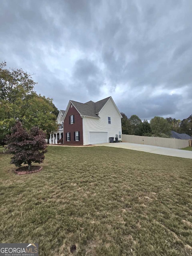 view of home's exterior featuring a lawn and a garage