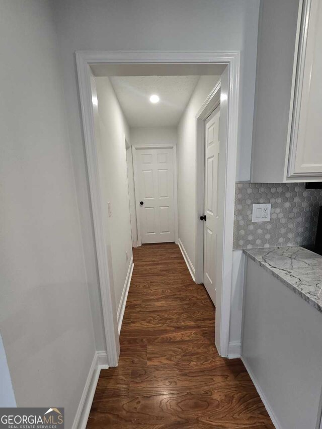 corridor featuring dark hardwood / wood-style floors