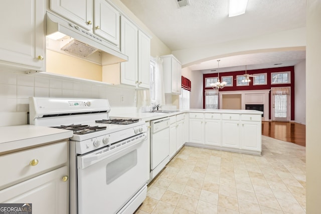 kitchen with a textured ceiling, white cabinetry, pendant lighting, and white appliances