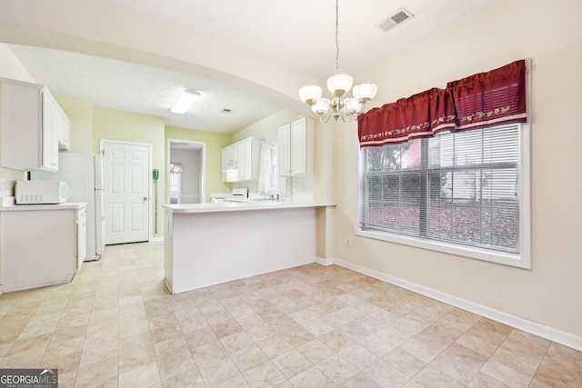 kitchen featuring white cabinetry, a notable chandelier, kitchen peninsula, pendant lighting, and light tile patterned floors