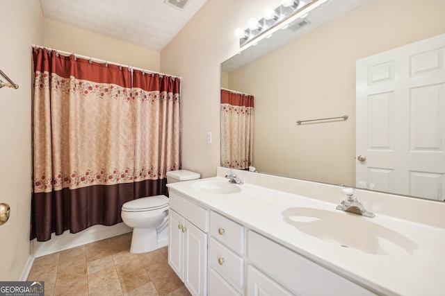 bathroom with a textured ceiling, vanity, toilet, and walk in shower