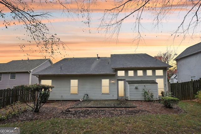 view of back house at dusk