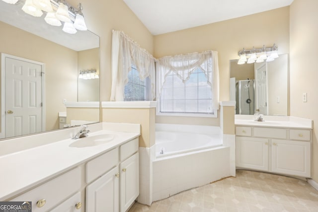 bathroom featuring shower with separate bathtub and vanity