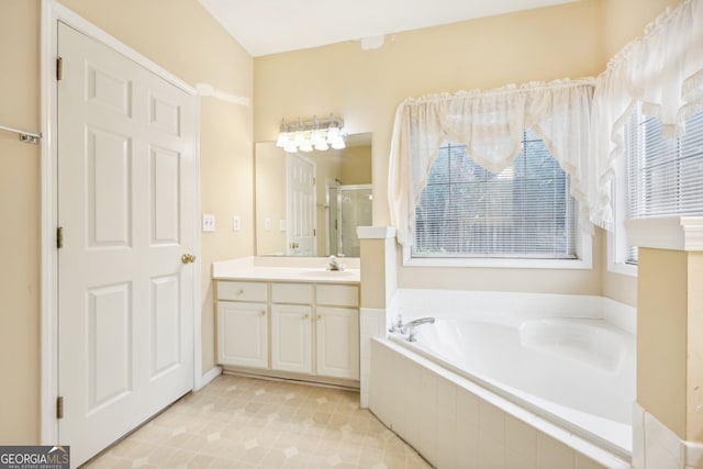 bathroom featuring vanity and shower with separate bathtub