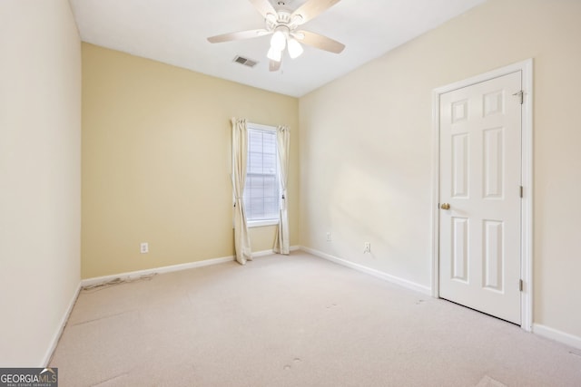 empty room with light carpet and ceiling fan