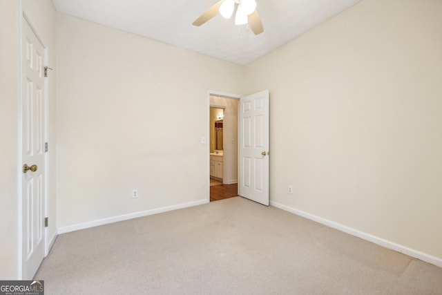 unfurnished bedroom featuring light colored carpet and ceiling fan