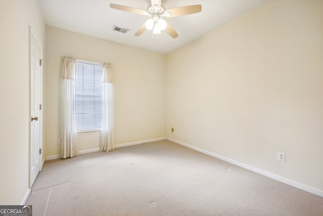 unfurnished room featuring light carpet and ceiling fan